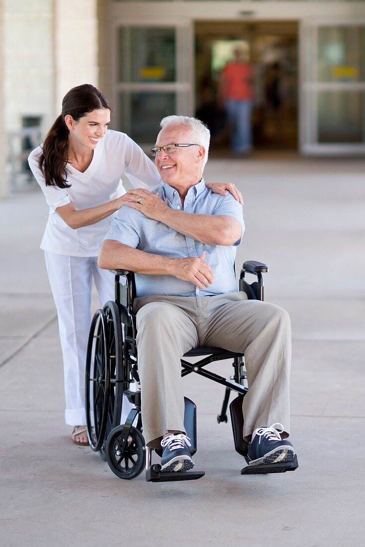 Senior man in wheelchair with care worker