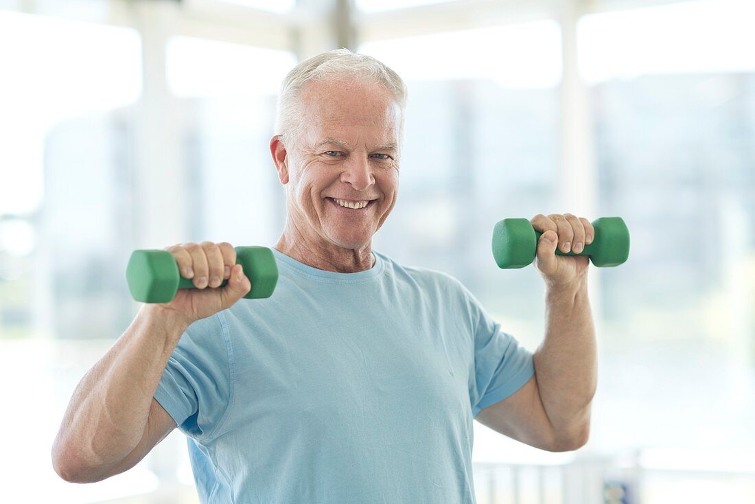 Senior man using weights