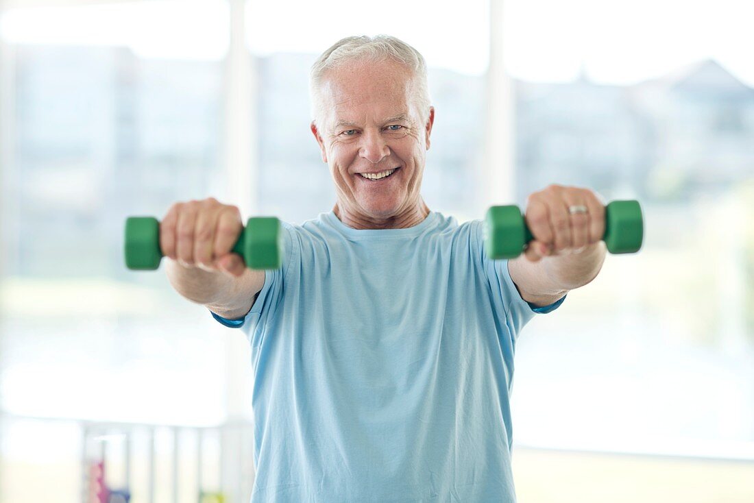 Senior man using weights