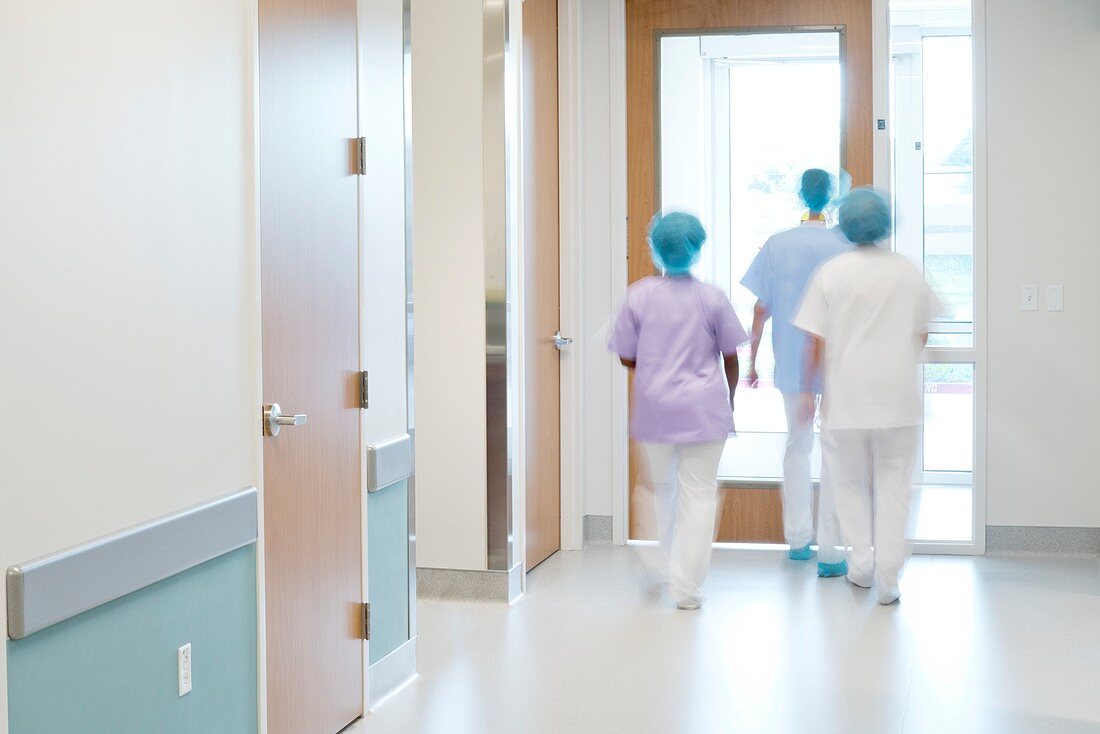 Medical staff walking down hospital corridor