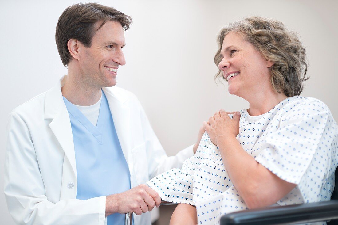 Doctor smiling at Woman patient