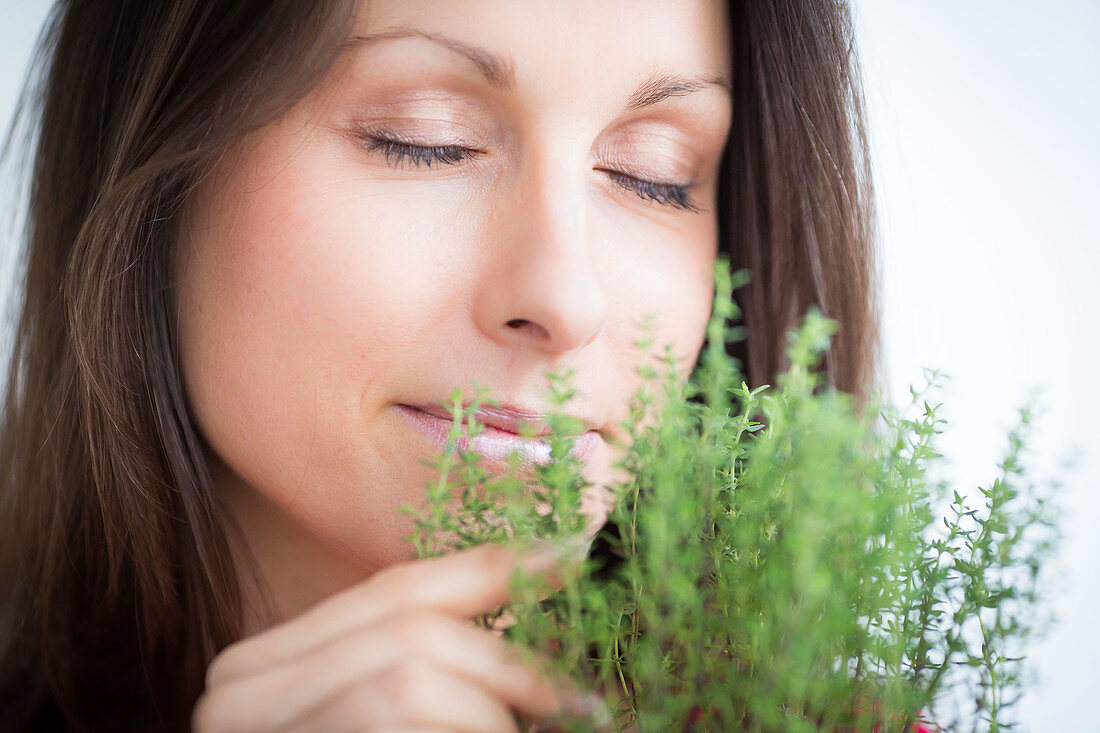 Woman inhaling thyme fragrance