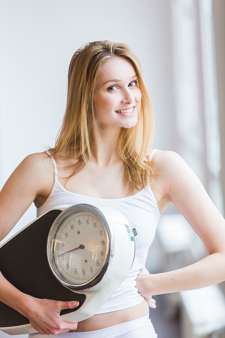 Woman holding on a scale