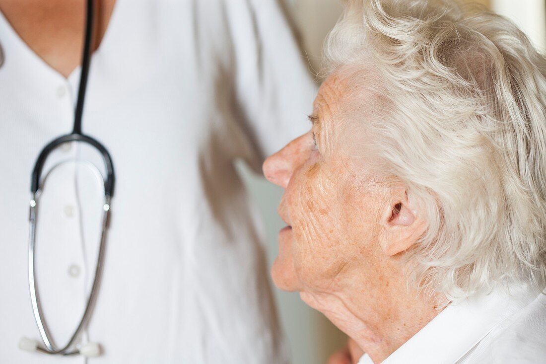 Elderly woman looking at doctor