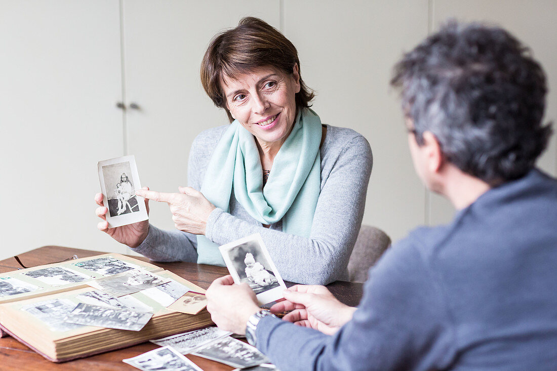Senior woman looking at family photographs