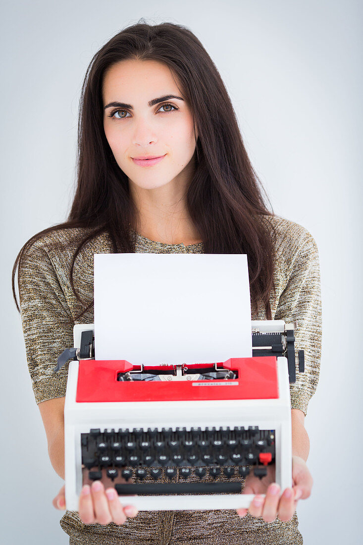 Woman holding a typewriter