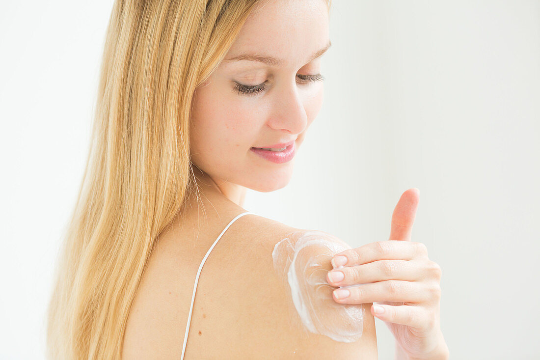 Skincare, Woman applying body cream