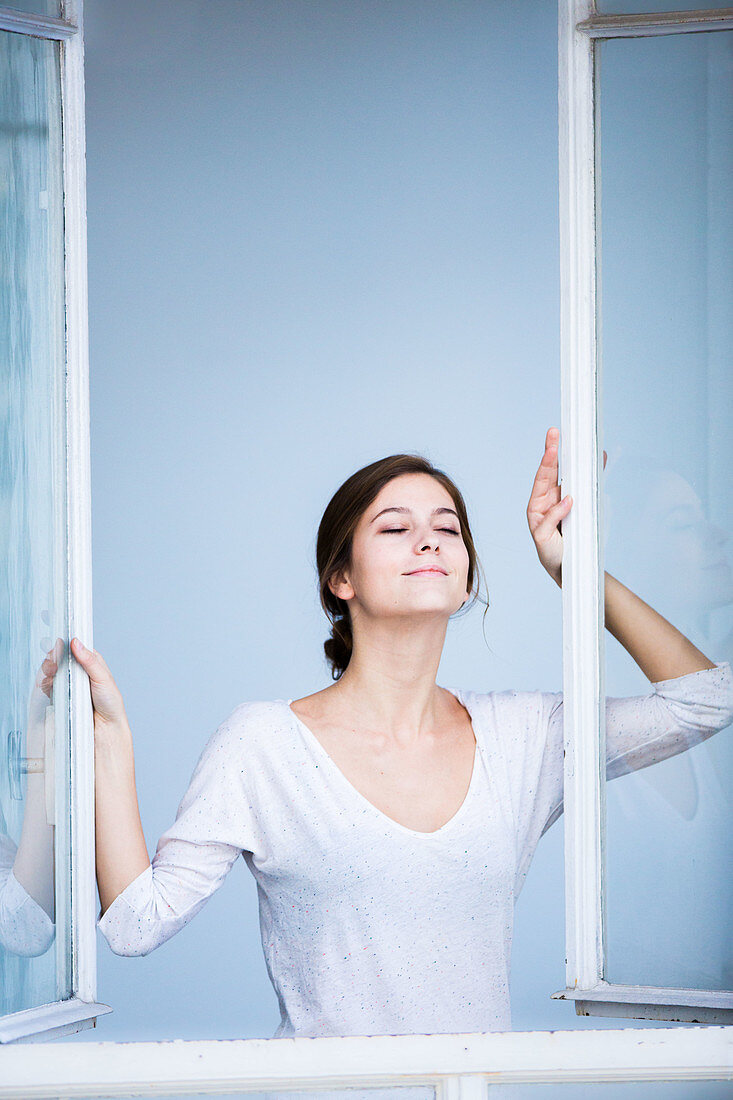 Woman opening window