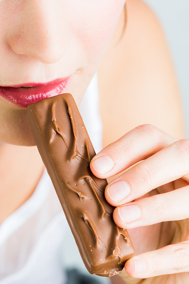 Woman eating a chocolate bar