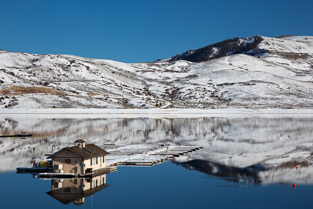 Floating dock on a reservoir in winter, USA
