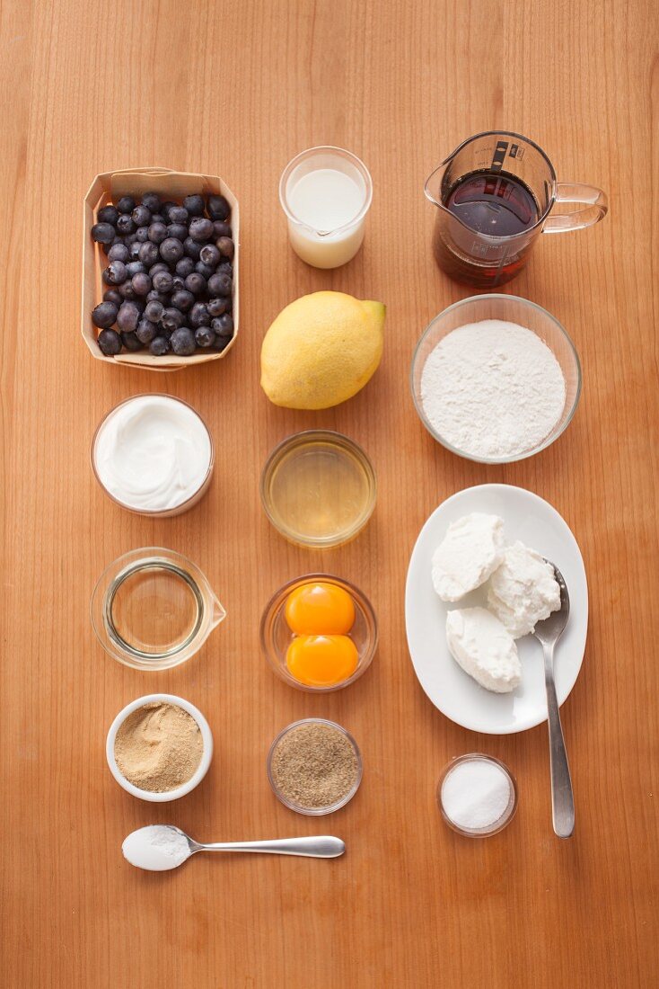 Ingredients for making blueberry pancakes with maple syrup