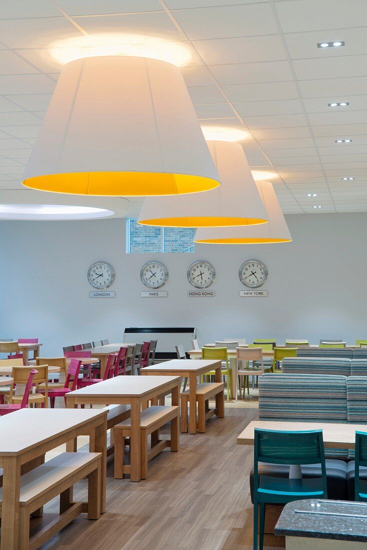 Large ceiling lamps and various tables and chairs in canteen