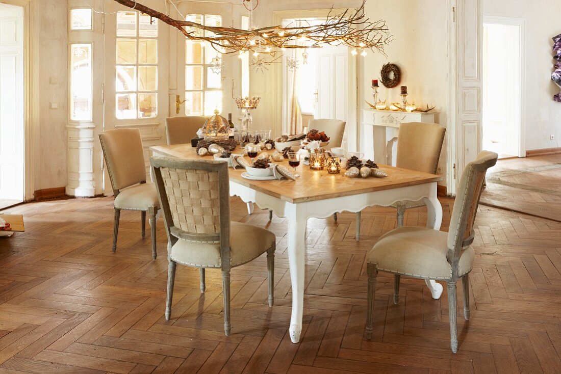 Christmas tree in period interior with herringbone parquet floor and set dining table