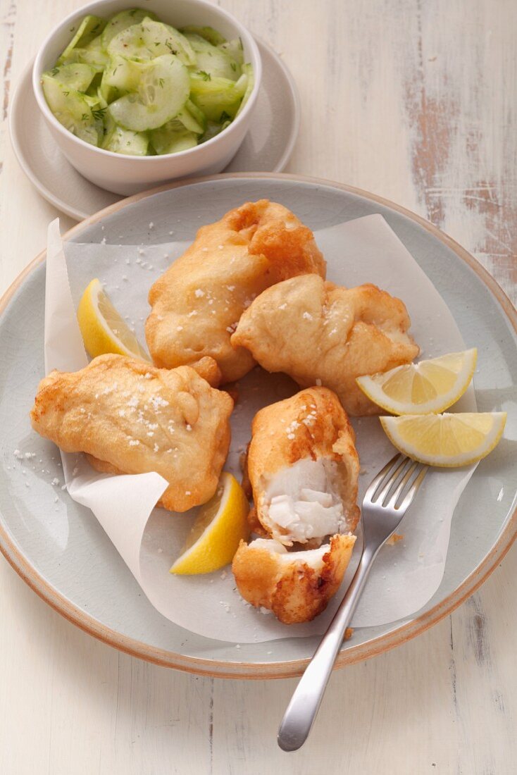 Fried fish in beer batter served with cucumber salad