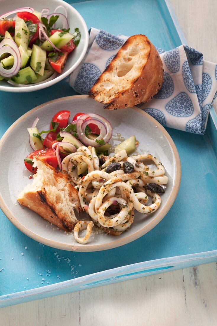 Fried calamari with tomato and cucumber salad