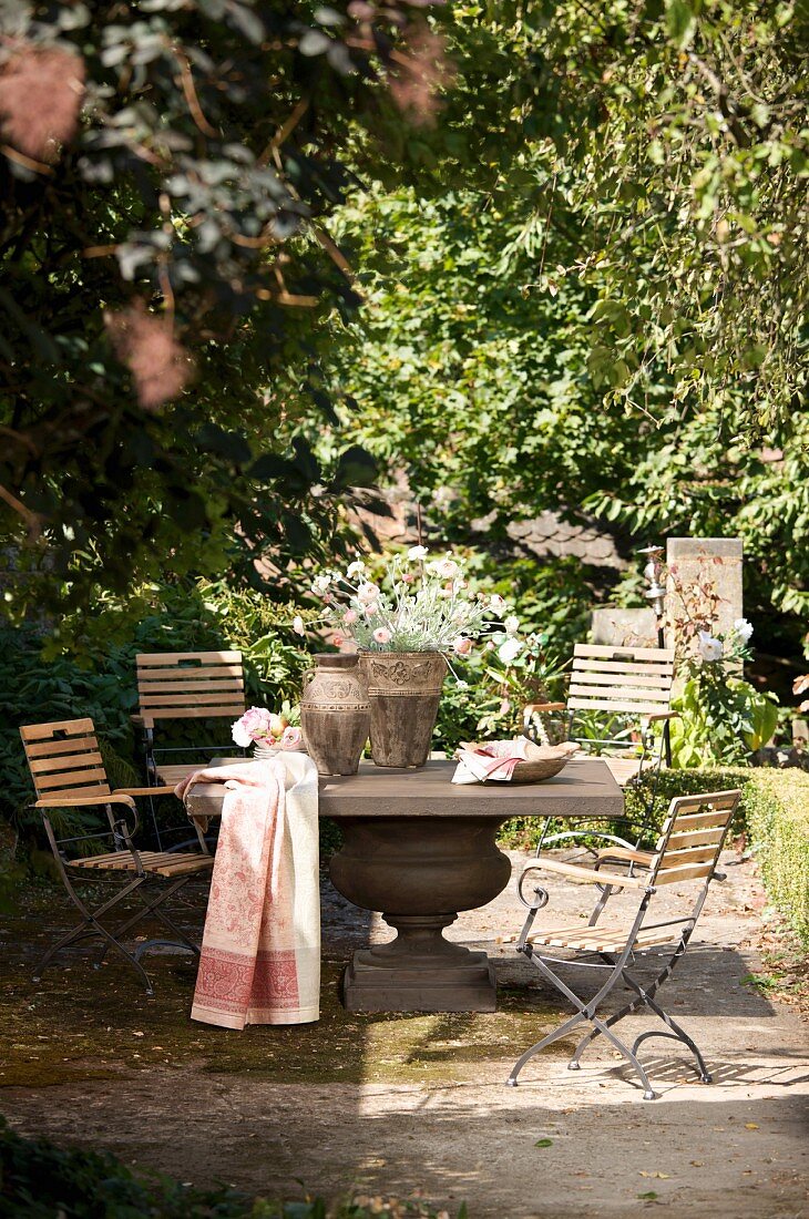 Solid stone table and chairs in seating area in garden