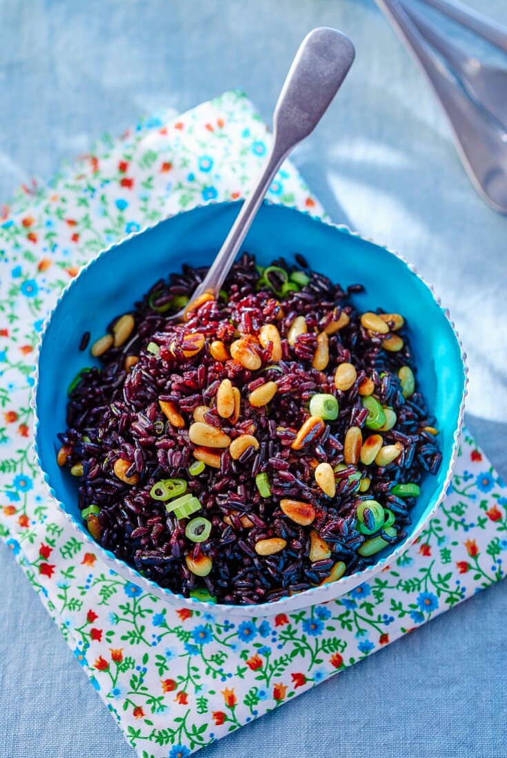 Rice salad with black rice, spring onion and pine nuts