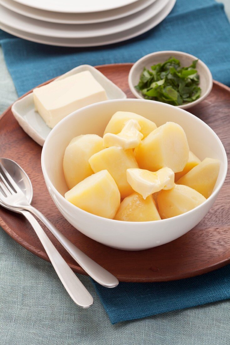 Peeled and boiled potatoes with butter