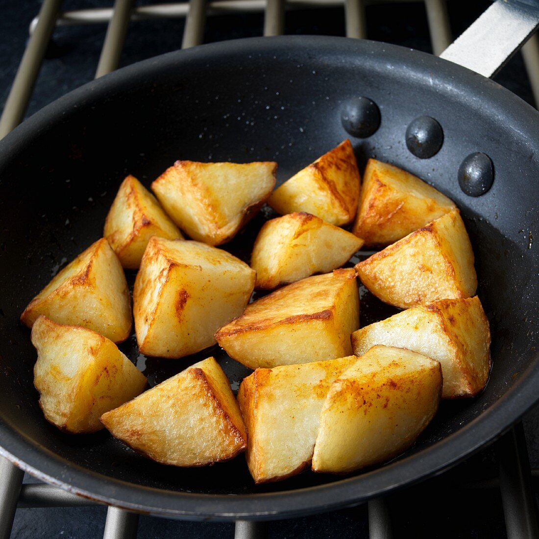 Fried potatoes in frying pan