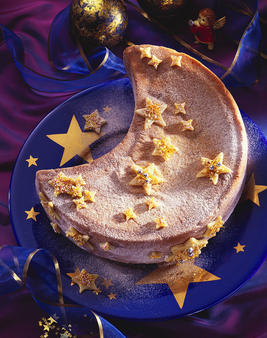 Half-moon shaped Christmas cake with marzipan stars