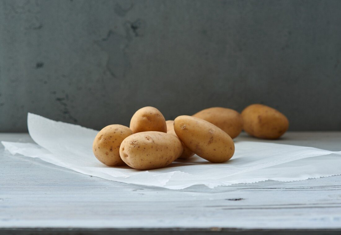 Several potatoes on a piece of paper