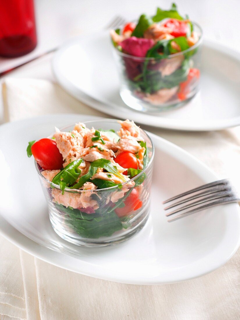 Fresh mixed salad with cherry tomatoes of Pachino and canned salmon in olive oil, Italy