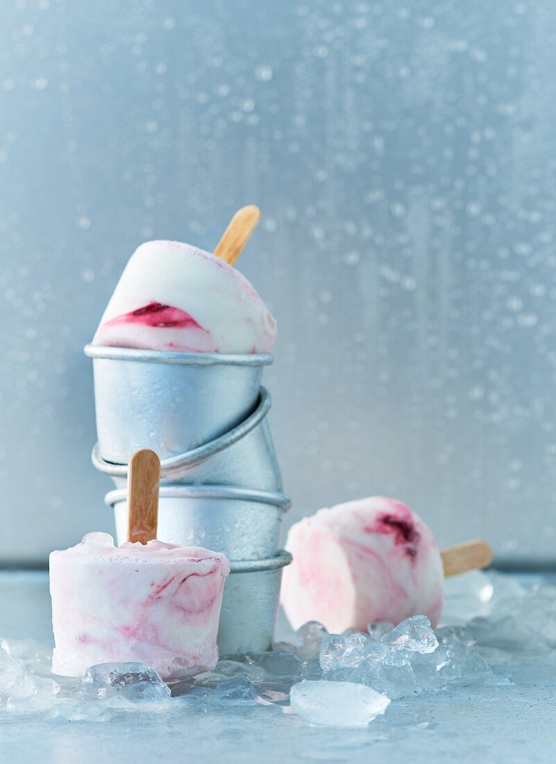 Homemade yoghurt, raspberry, and blackberry ice lollies with moulds
