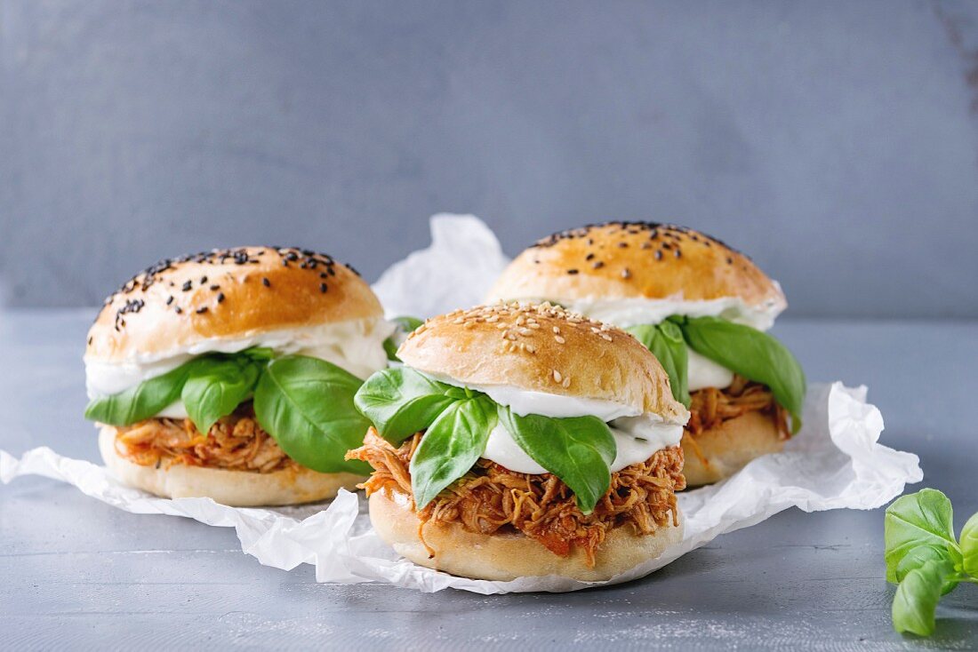 Homemade mini burgers with pulled chicken, basil, mozzarella cheese and yogurt sauce