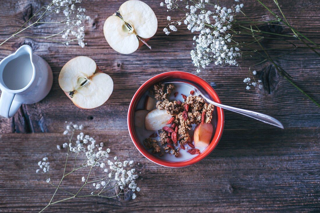 Granola with apples and oat milk served in a bowl