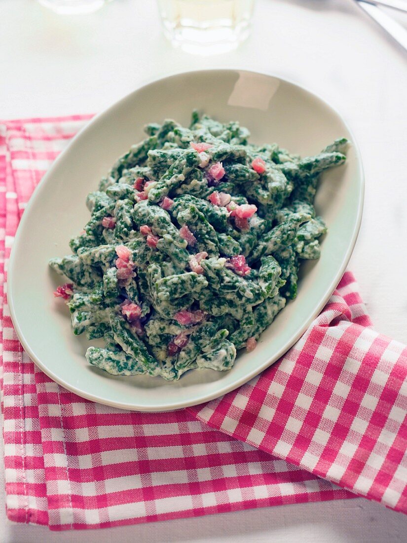Traditional spinach Spätzle pasta with speck and cooking cream, Trentino, Italy, Europe