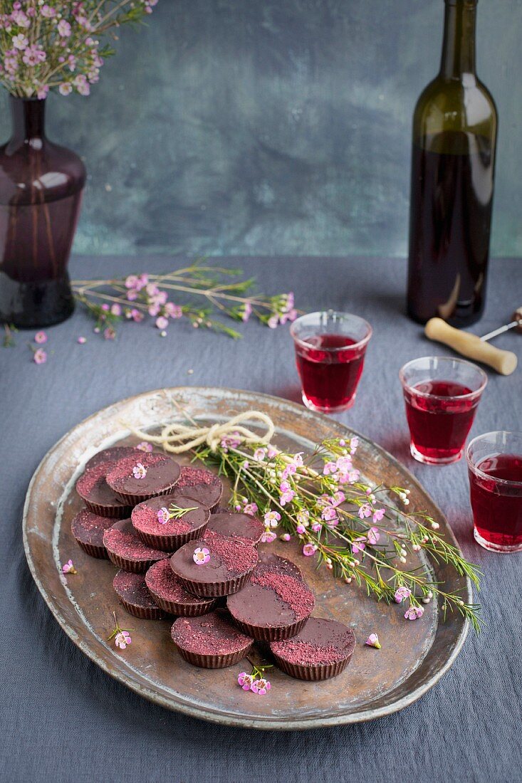 Marzipan Hibiscus Cups served on a copper tray with a dessert wine
