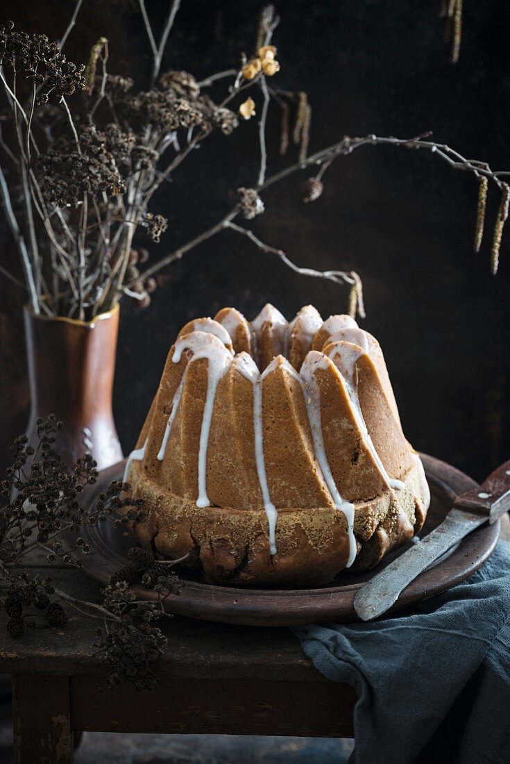 Nut gugelhupf with a sugar frosting and blossoms
