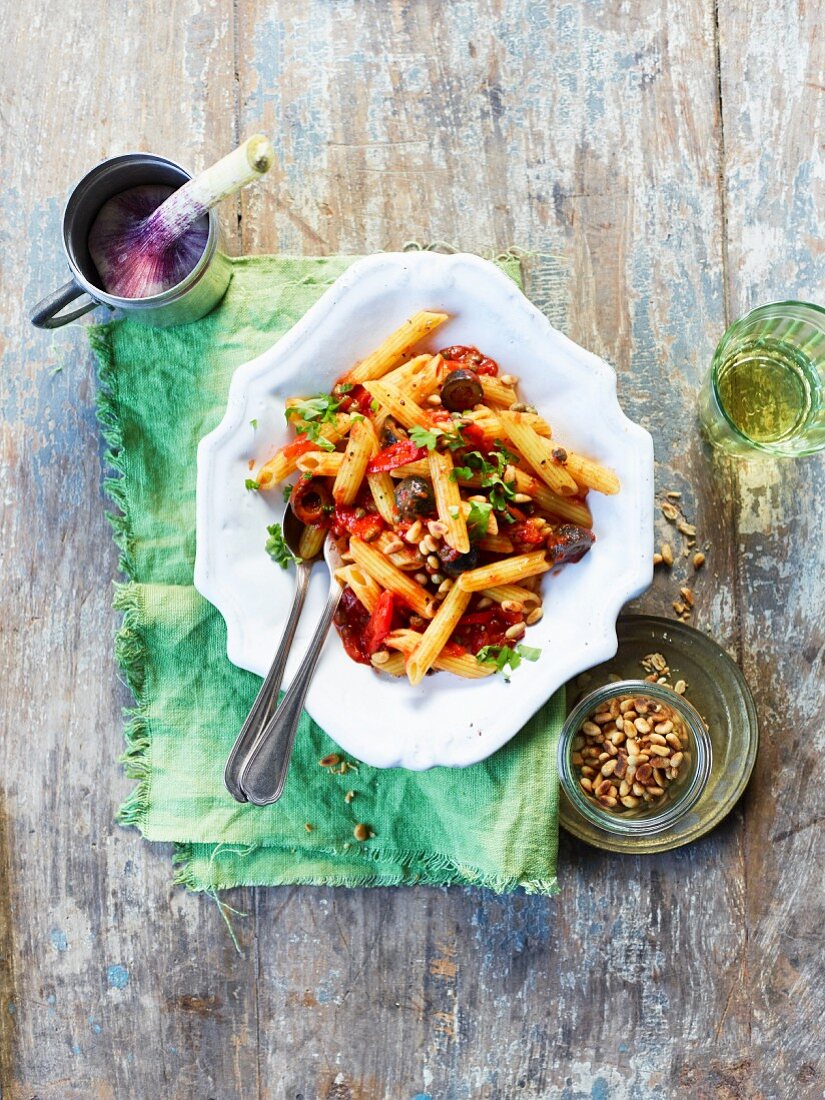 Pasta puttanesca salad with pine nuts