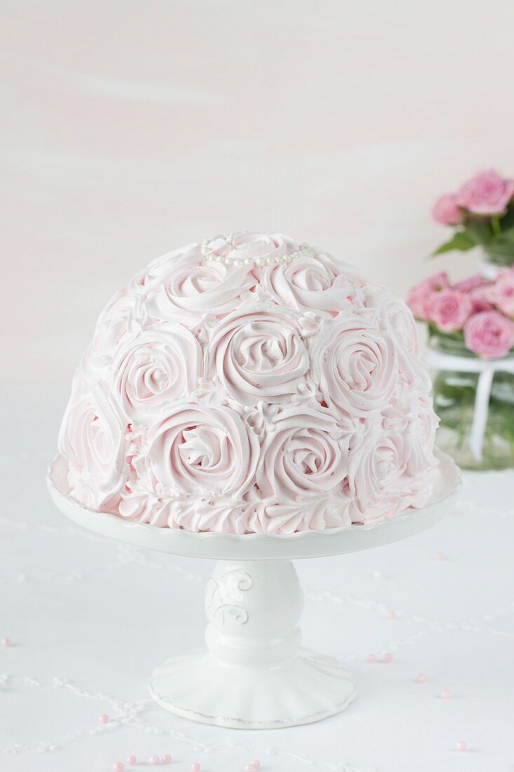 A rose cake on a cake stand