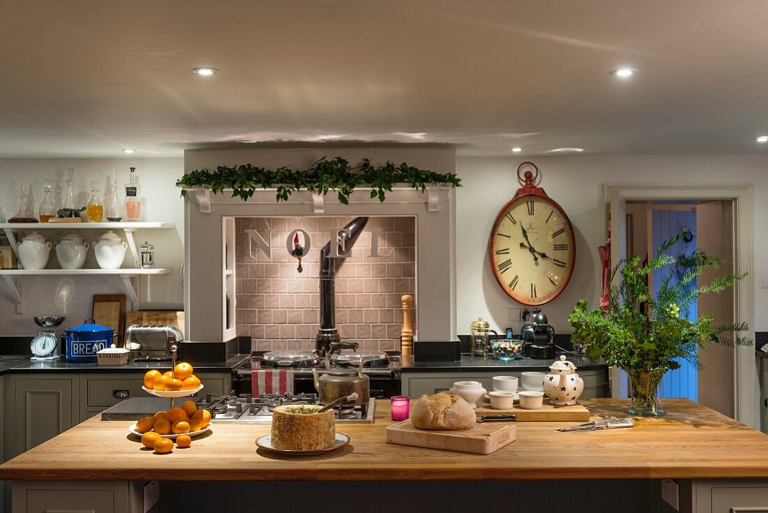 Island counter and Christmas decorations in traditional country-house kitchen