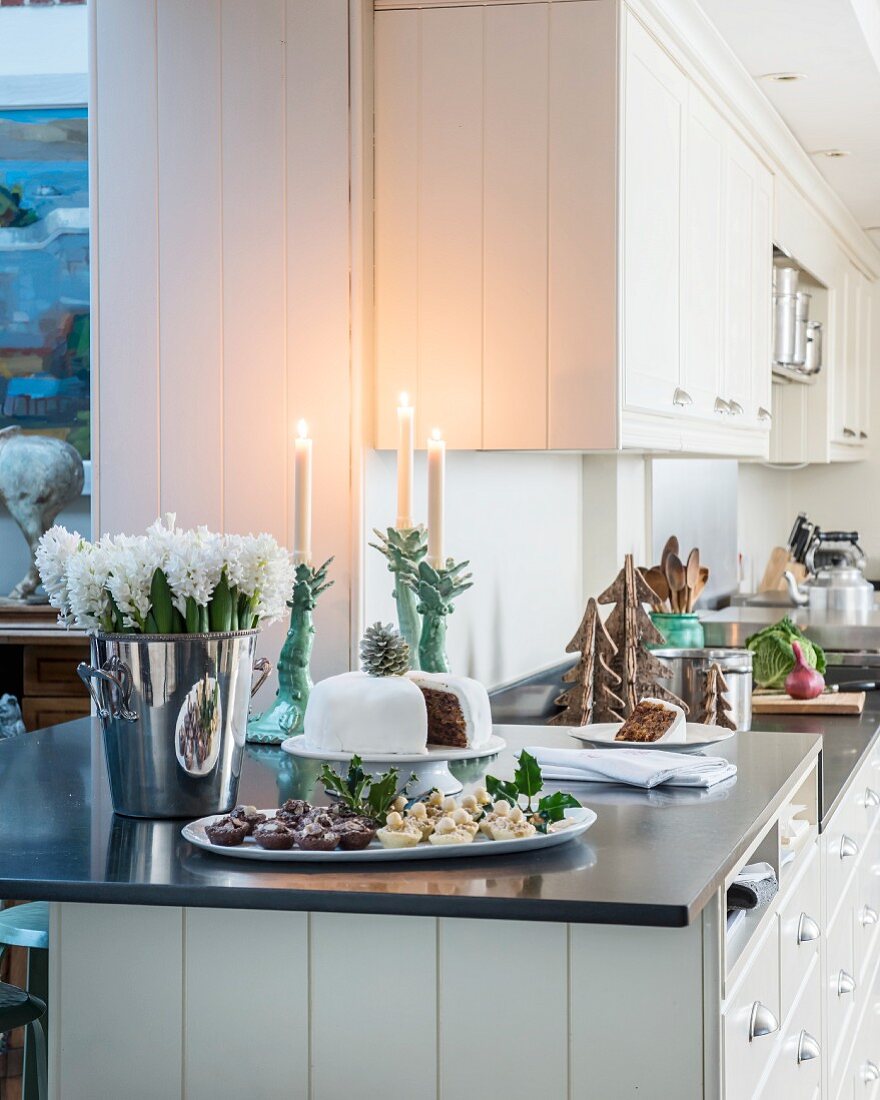 Cake and flowers on festively decorated kitchen counter