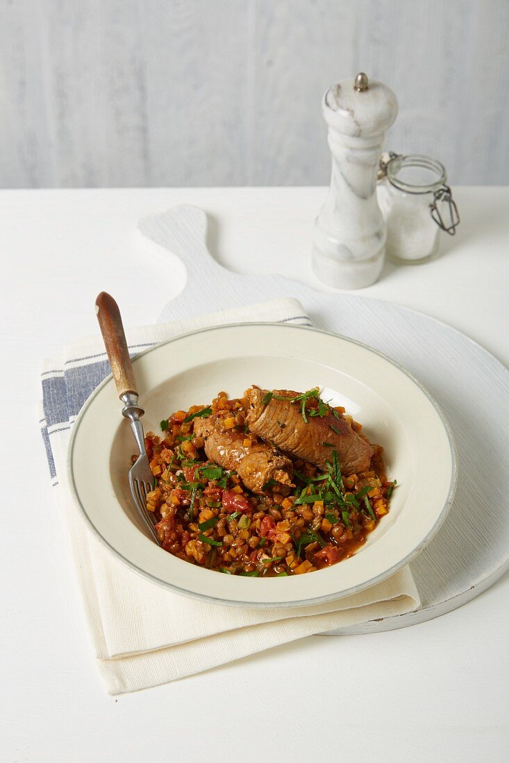 Rolled veal on a bed on lentil and vegetable ragout