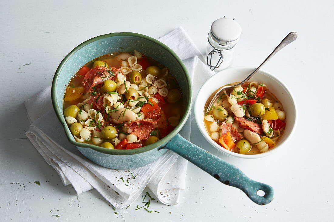 Bean stew with red and yellow pepper, olives and chorizo