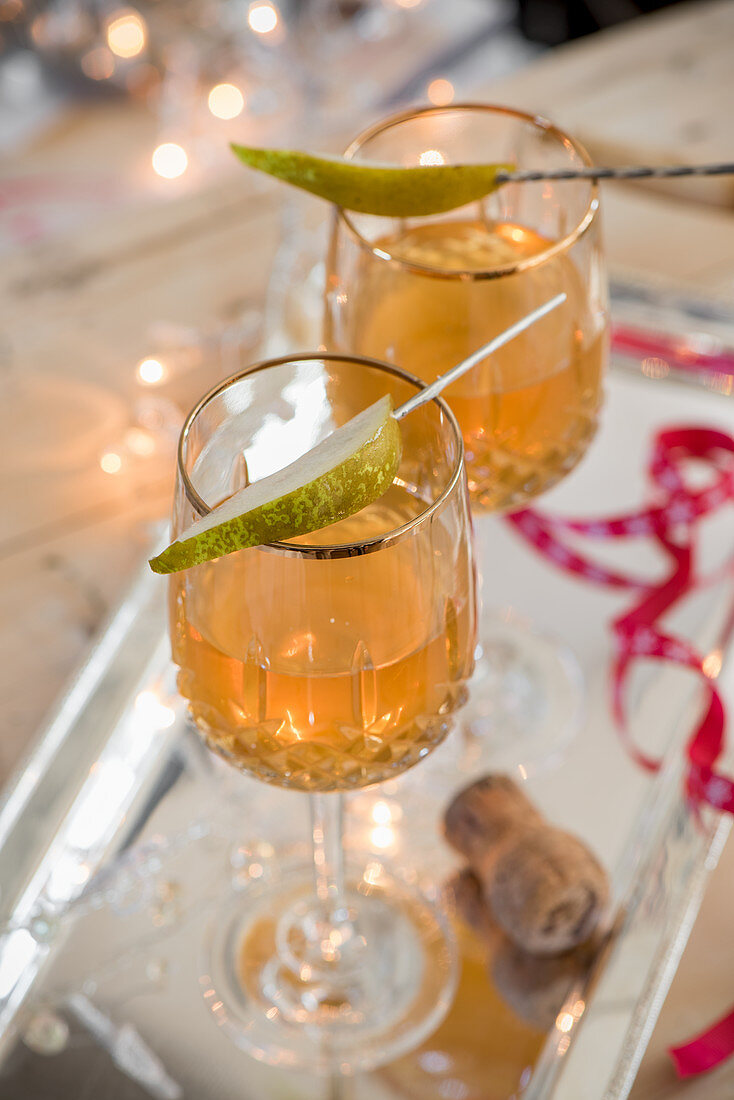 Homemade pear vodka in crystal glasses for Christmas