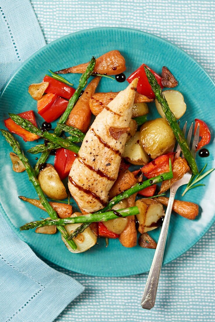 Grilled chicken breast on roasted vegetables