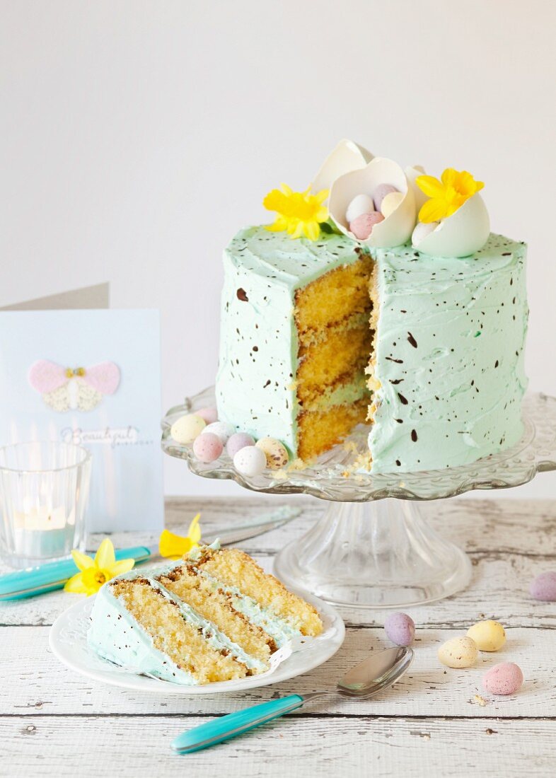White chocolate cake with chocolate, easter eggs and daffodil flowers