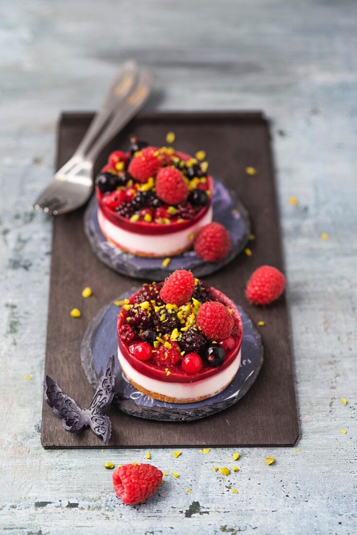 Two mini fancy cakes with berries