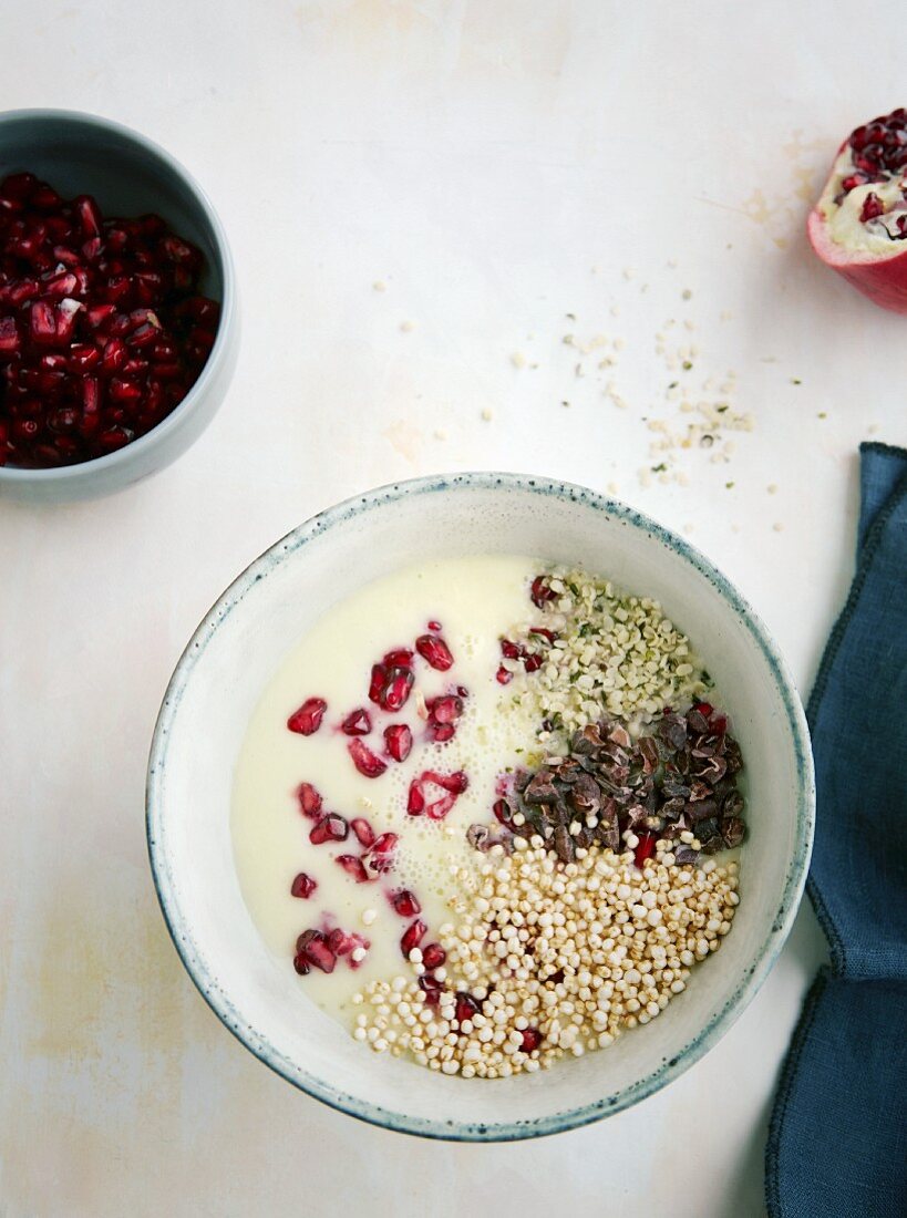 A pineapple and banana bowl with hemp, pomegranate seeds and popped quinoa