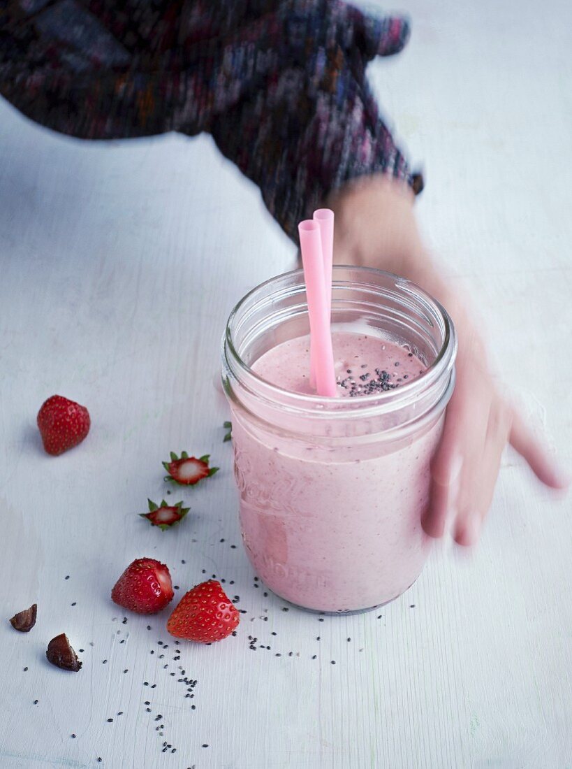 A breakfast shake with coconut milk, strawberries and chia seeds