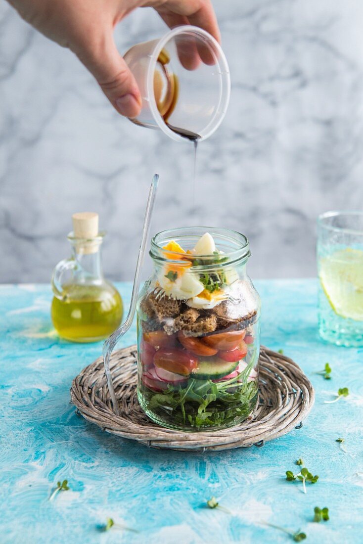 Panzanella salad with balsamic dressing in a glass jar