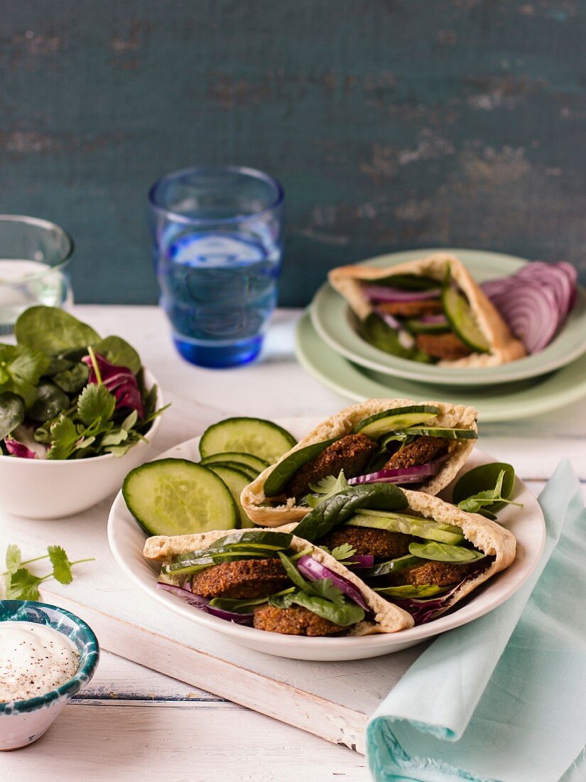 Falafel in pita bread with cucumbers, red onion, spinach and coriander