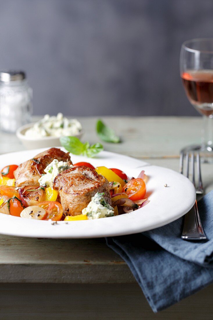 Pork medallions with yellow pepper and cherry tomatoes