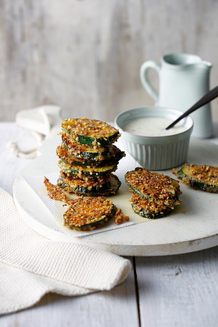 Crispy courgette slices in an almond and parmesan coating with herb aioli