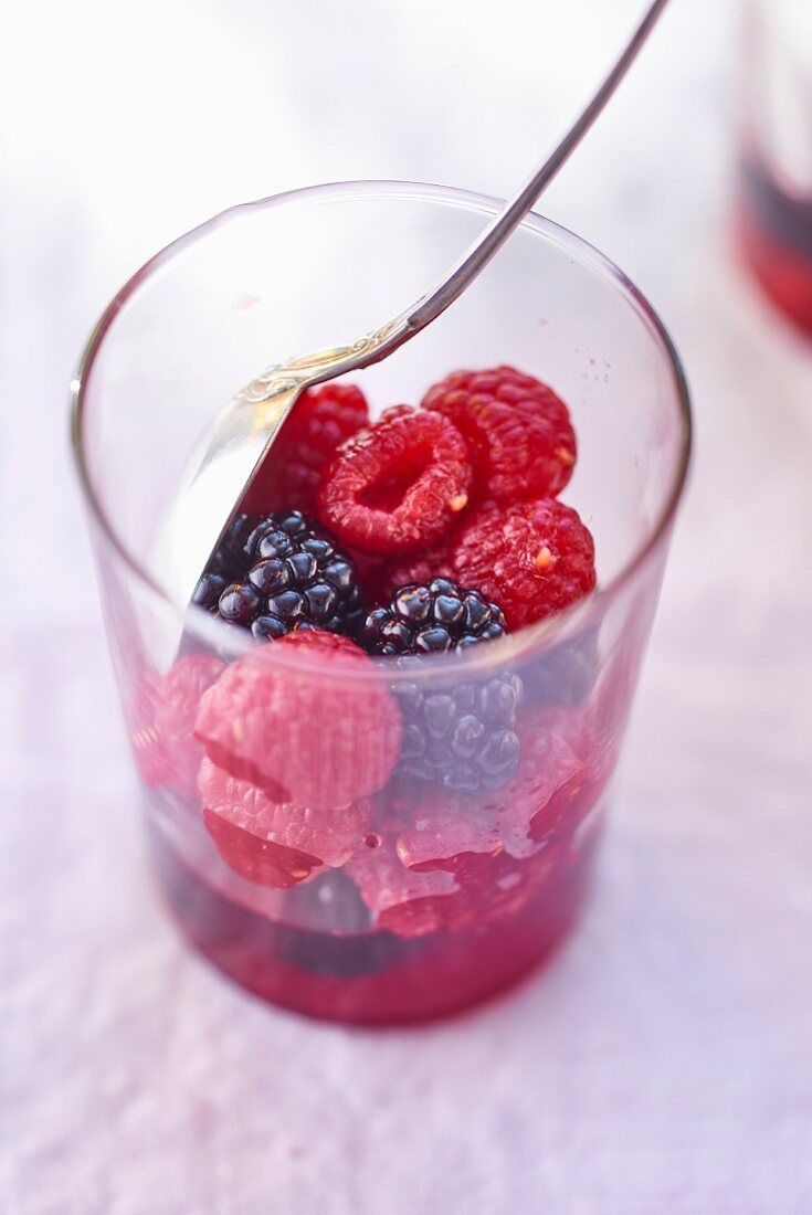 Raspberries and blackberries in a glass
