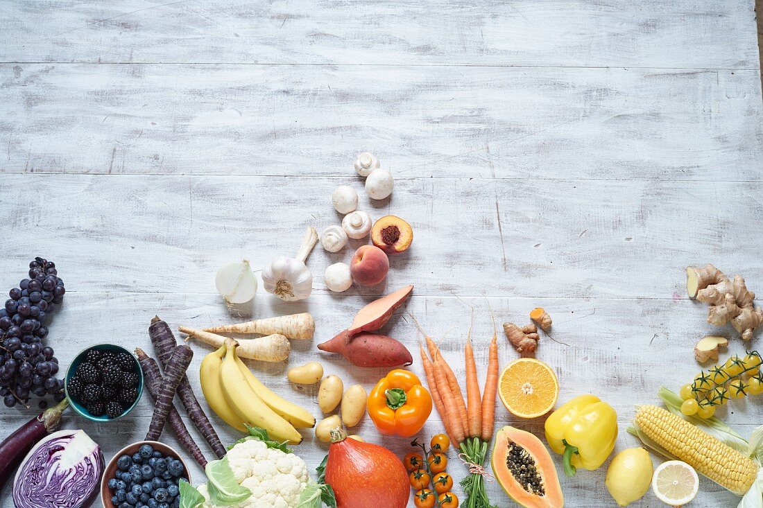 Blue, white, yellow and orange fruit and vegetables